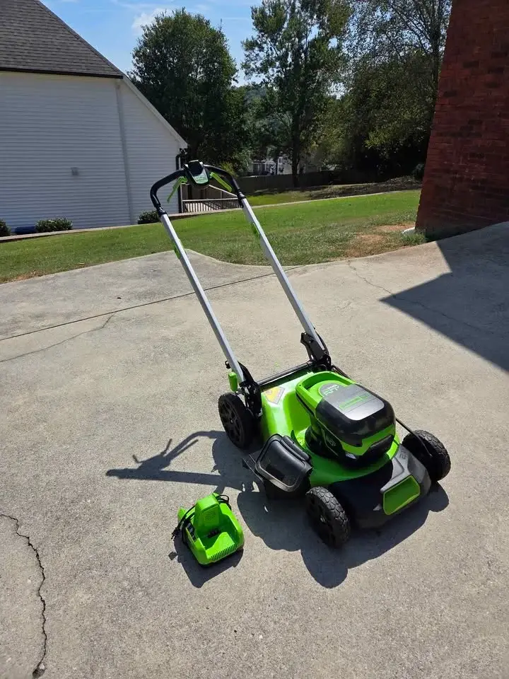 Mowing a green lawn with a Mowertec lawn mower